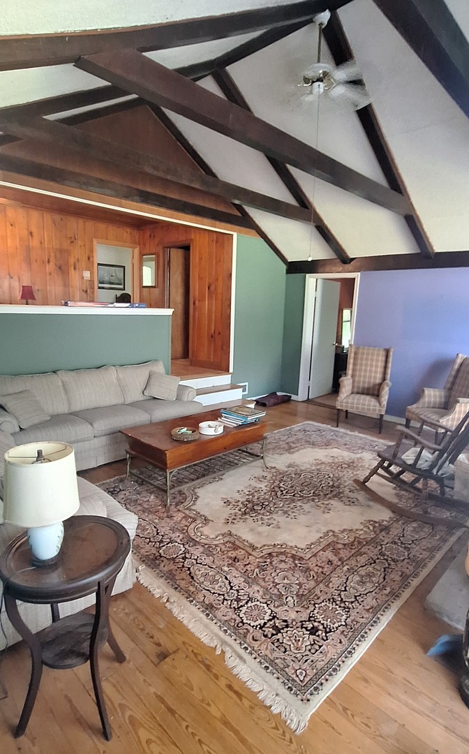6704 South Rawson Bridge Road Cary, IL 60013 - Photo 7 of 10 a living room filled with furniture and a rug