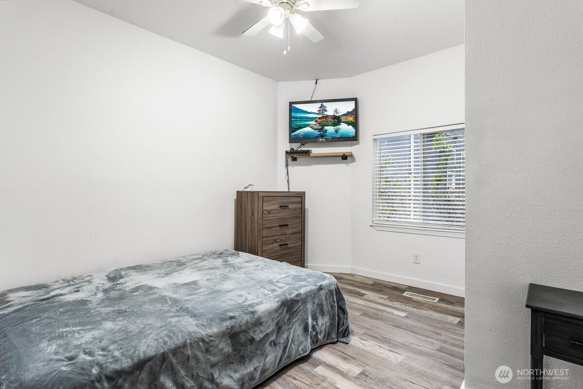 1916 Martin Luther King Junior Way Tacoma, WA 98405 - Photo 14 of 17 a bedroom with a bed and a flat screen tv