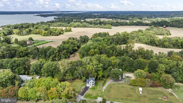 an aerial view of residential houses with outdoor space and trees