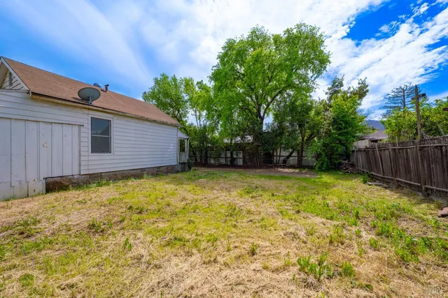 a front view of house with yard and trees