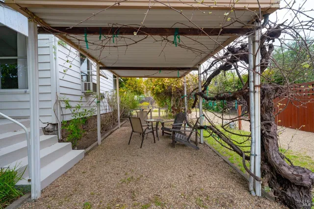 a view of a chairs and table in the patio