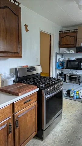 a kitchen with stainless steel appliances granite countertop a stove and a microwave