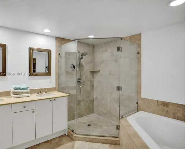 a bathroom with a shower sink and mirror
