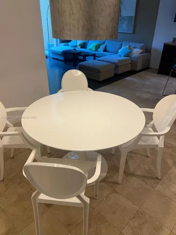 a front view of a house with table and chairs