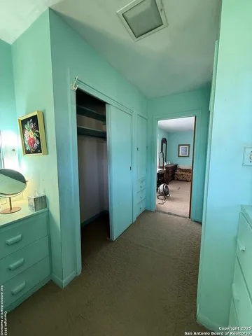 a view of a hallway to rooms and stairs