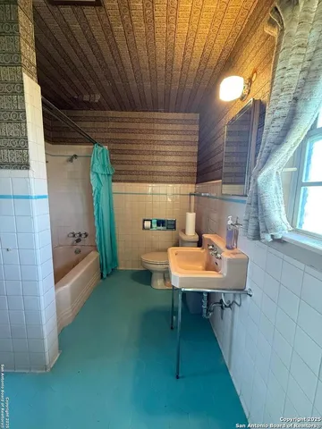 a backyard of a house with a table and chairs