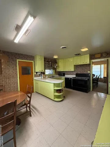 a living room with furniture and kitchen view