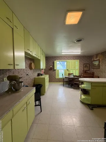 a kitchen with stainless steel appliances a sink cabinets and wooden floor