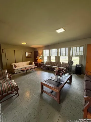 a living room with furniture and a pool table