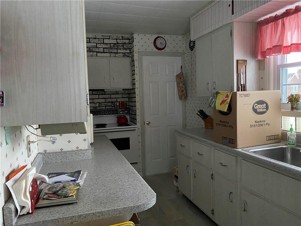 2300 Cottage Avenue Natrona Heights, PA 15065 - Photo 5 of 15 a kitchen with stainless steel appliances granite countertop a refrigerator and a stove