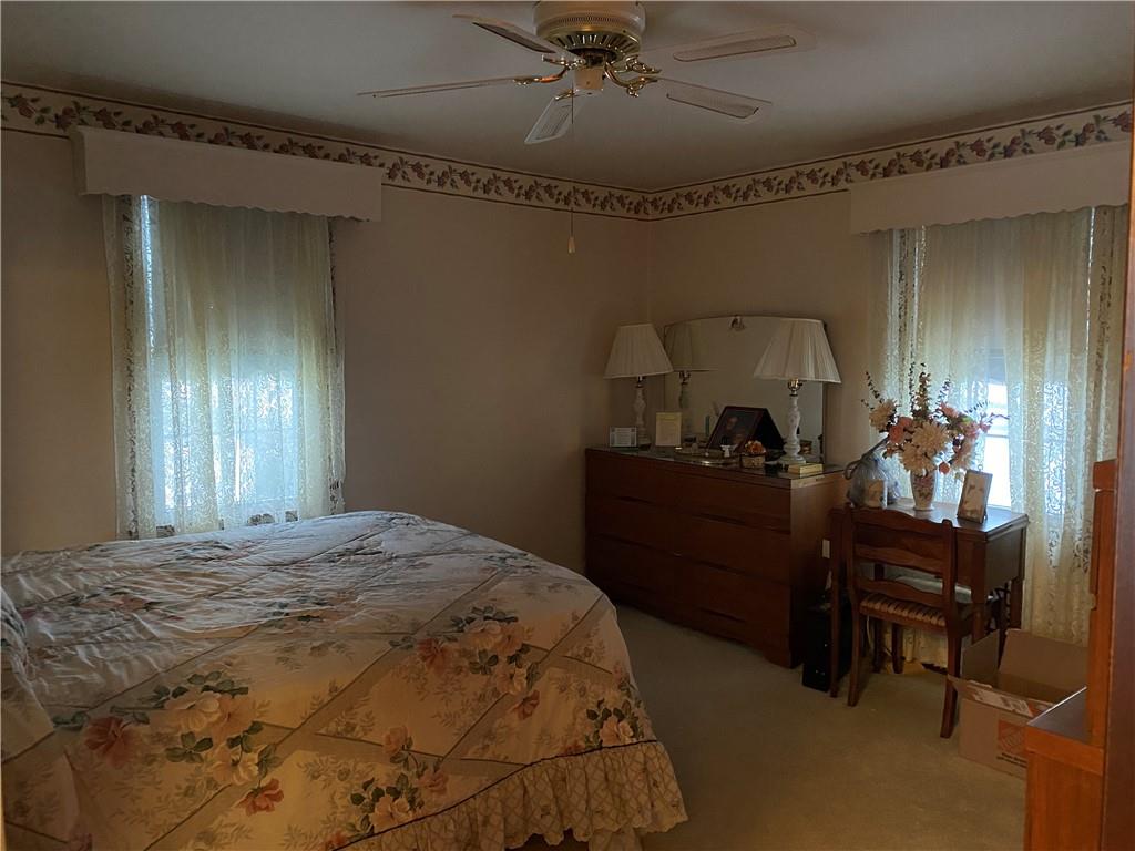 2300 Cottage Avenue Natrona Heights, PA 15065 - Photo 8 of 15 a bedroom with a bed and a chandelier