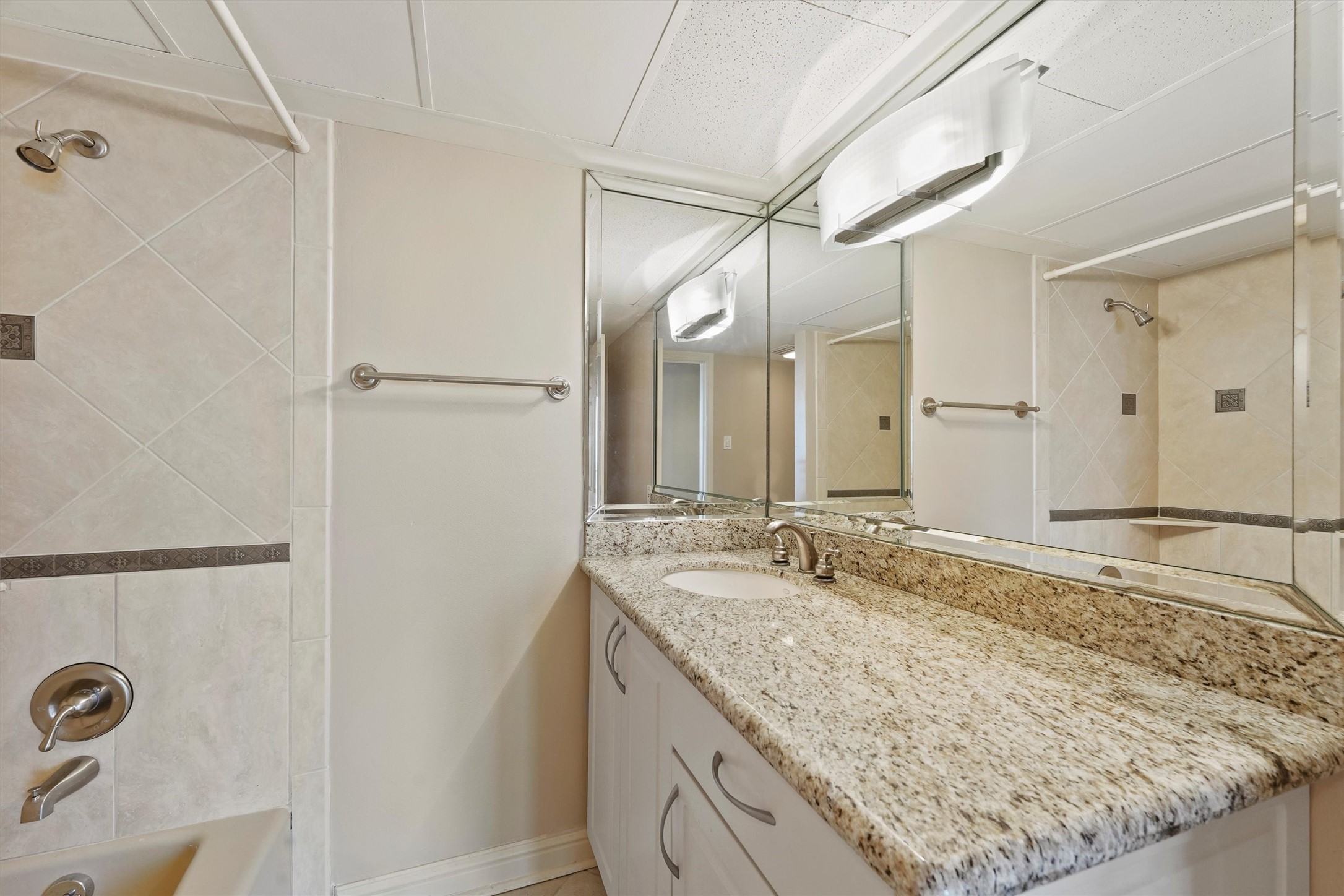 3350 McCue Road, Unit 2301 Houston, TX 77056 - Photo 16 of 31 a bathroom with a granite countertop sink and a mirror