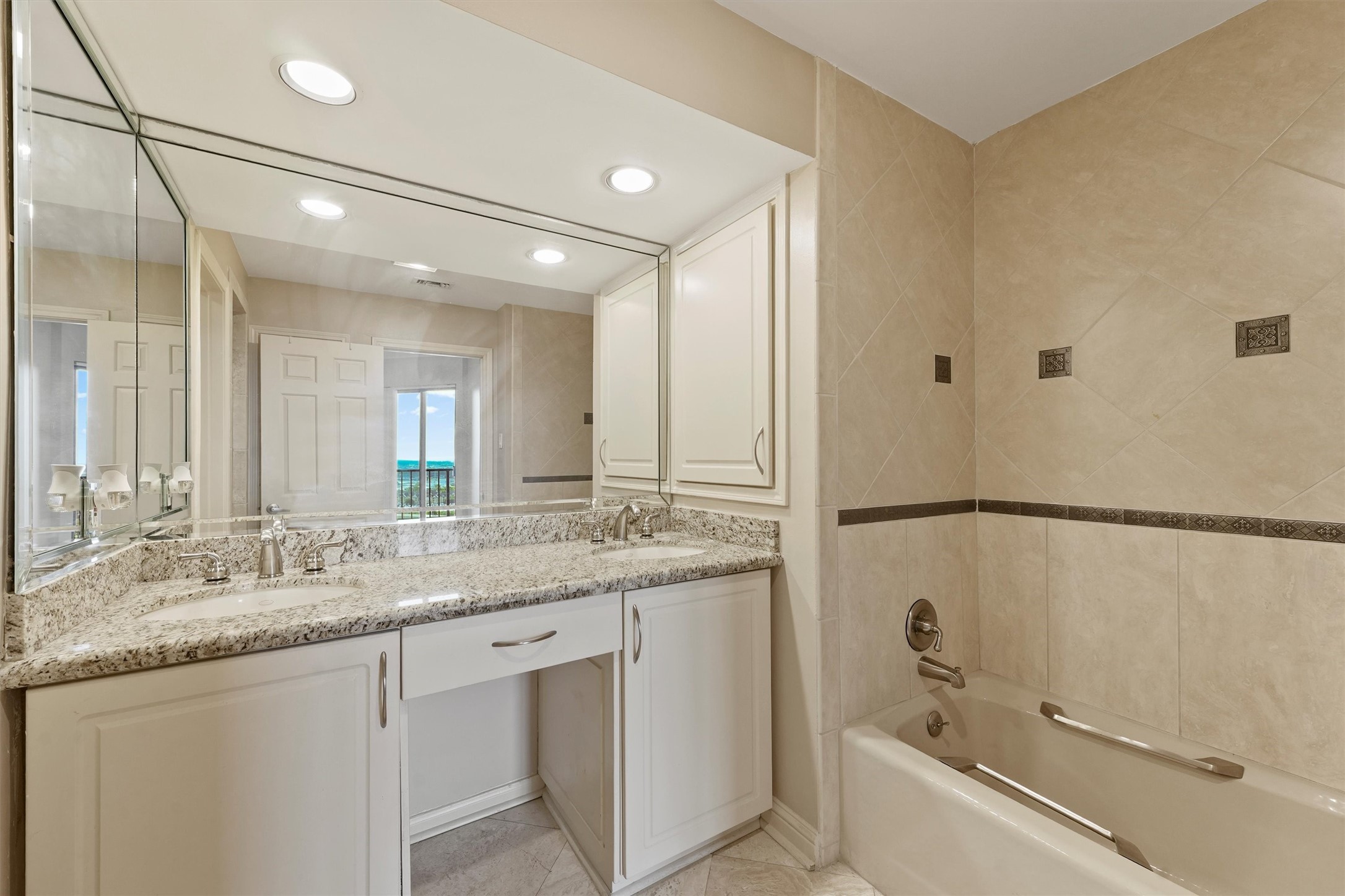 3350 McCue Road, Unit 2301 Houston, TX 77056 - Photo 21 of 31 a bathroom with a granite countertop sink and a mirror a bathtub