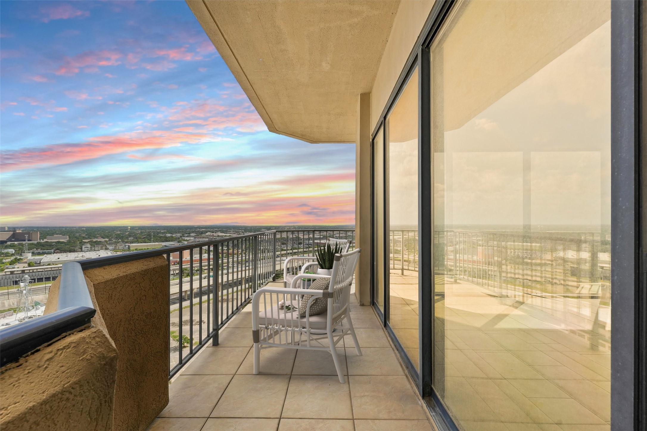 3350 McCue Road, Unit 2301 Houston, TX 77056 - Photo 5 of 31 a view of a balcony with chair and floor to ceiling window