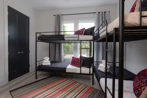 a bed sitting in a bedroom next to a lamp