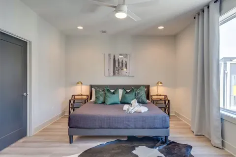 a bedroom with a bed and a chandelier