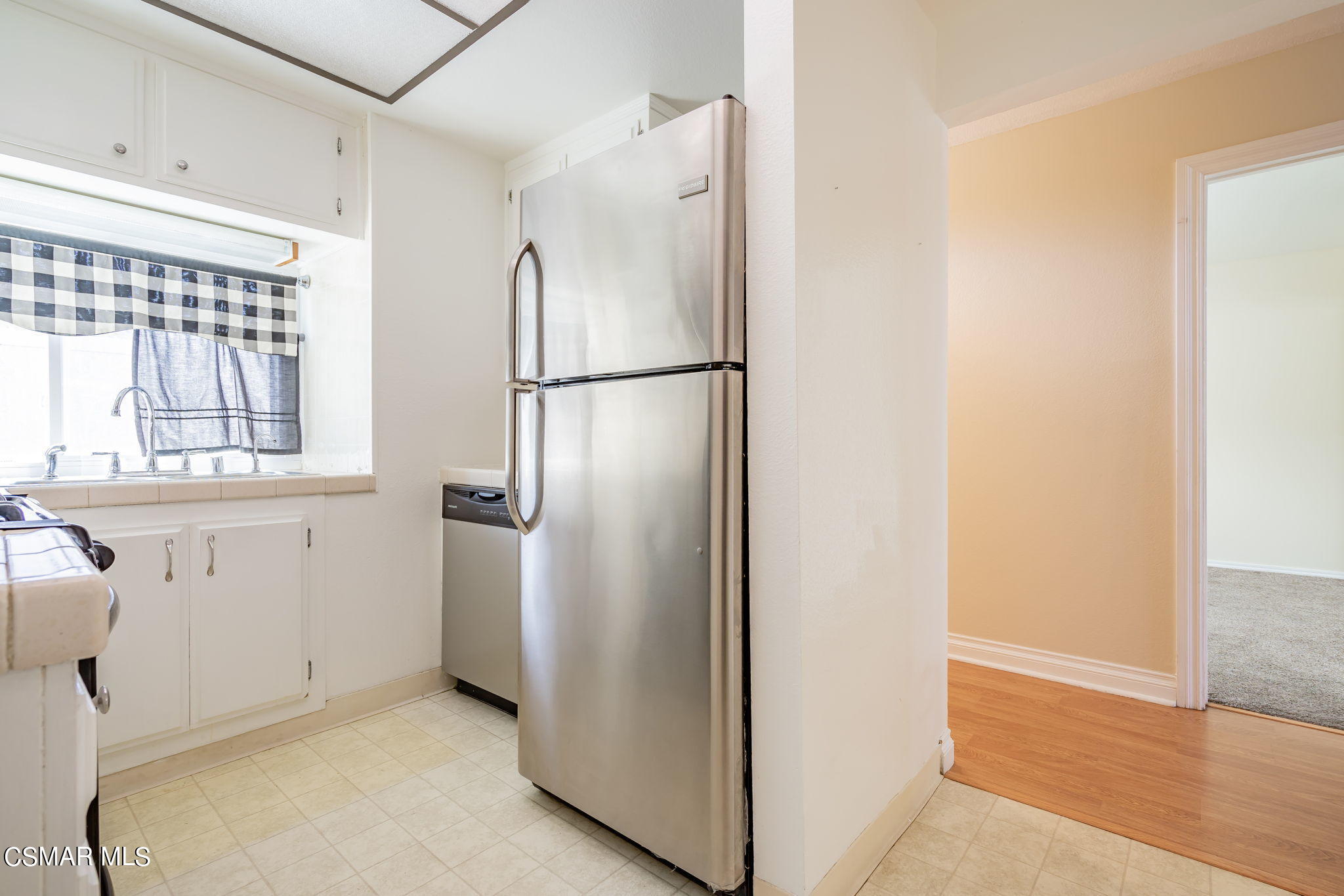 6392 Katherine Road, Unit C Simi Valley, CA 93063 - Photo 14 of 31 a view of a kitchen with a refrigerator and a window