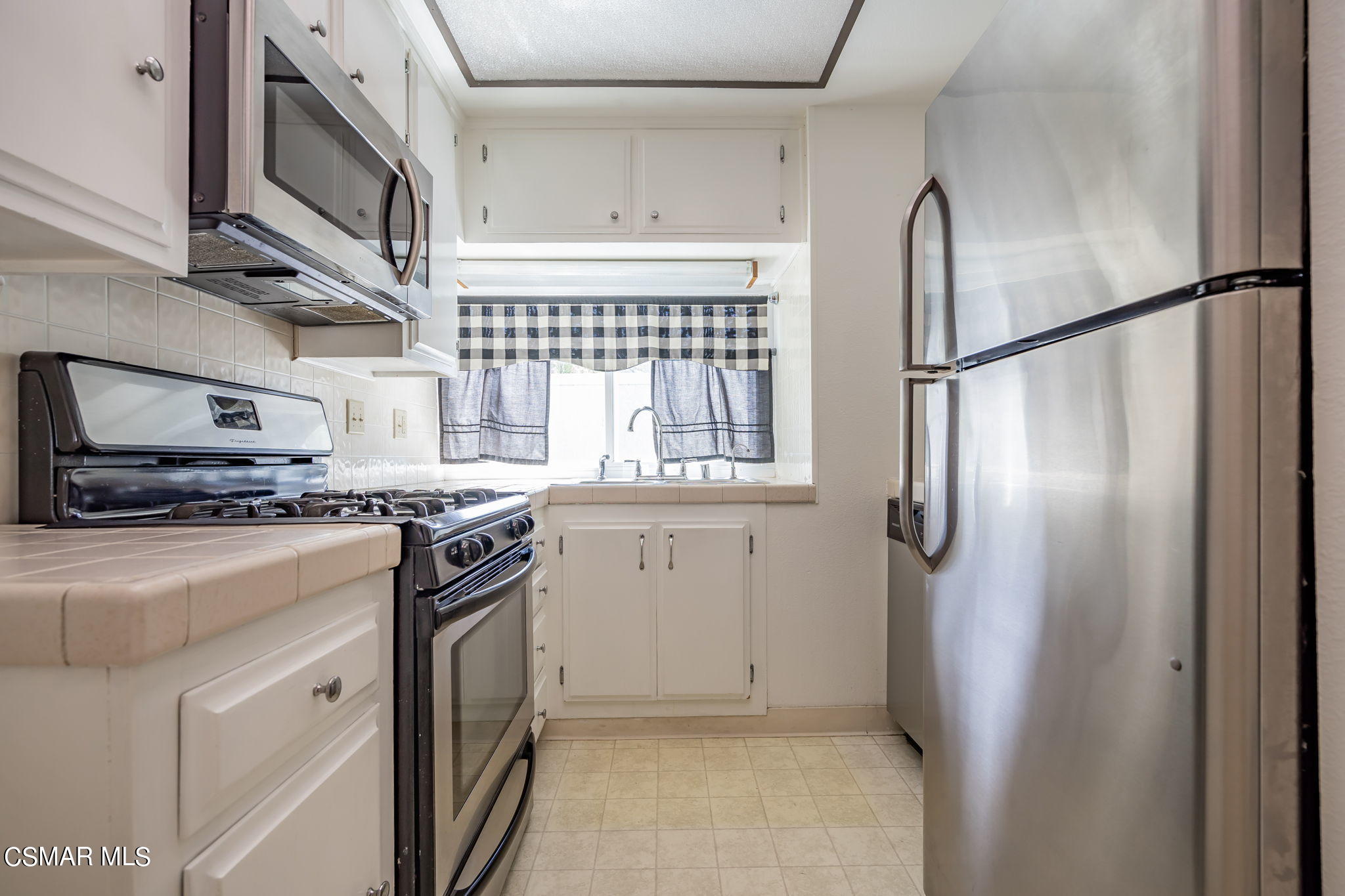 6392 Katherine Road, Unit C Simi Valley, CA 93063 - Photo 15 of 31 a kitchen with stainless steel appliances granite countertop a refrigerator a stove and a sink