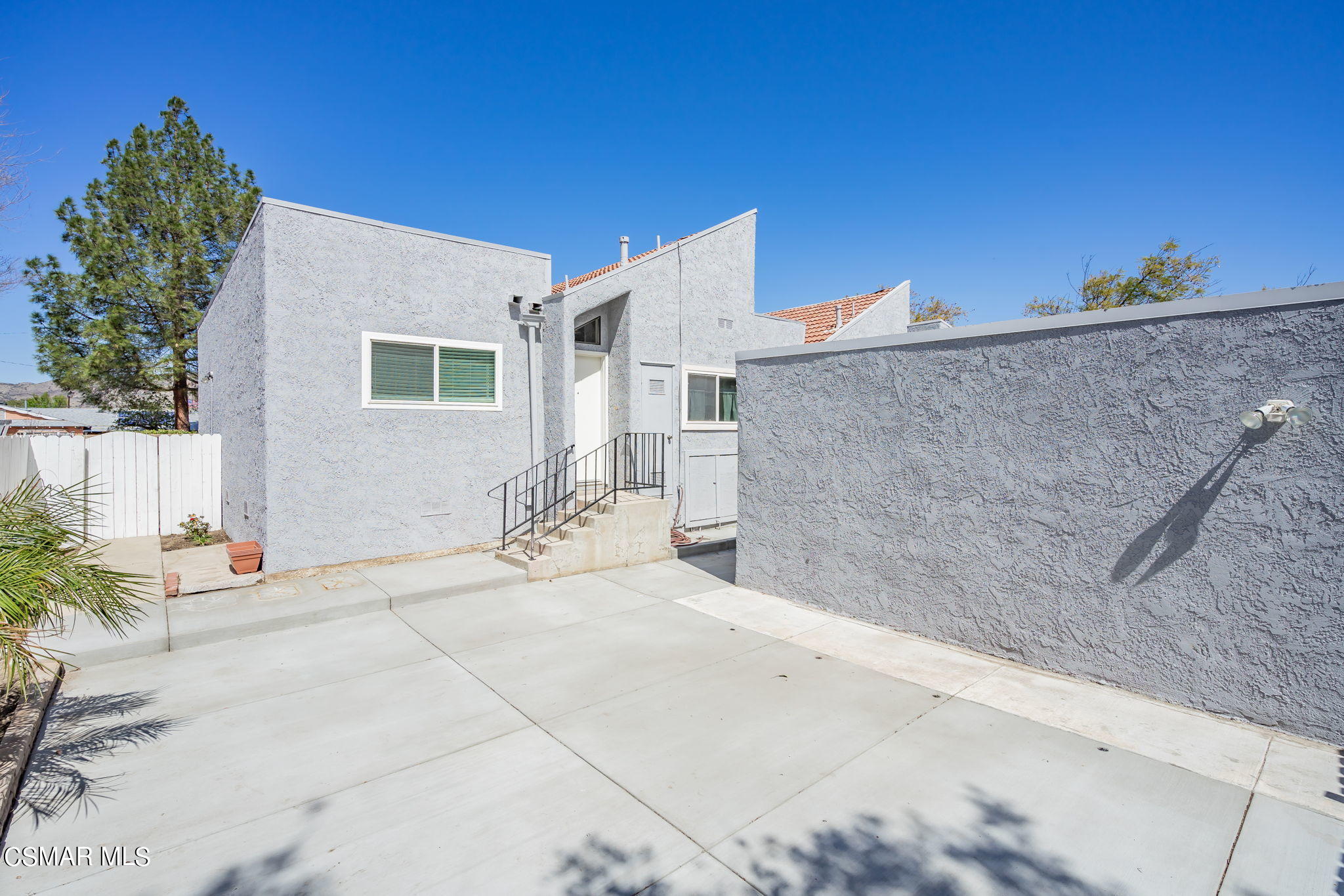 6392 Katherine Road, Unit C Simi Valley, CA 93063 - Photo 4 of 31 a backyard of a house with table and chairs