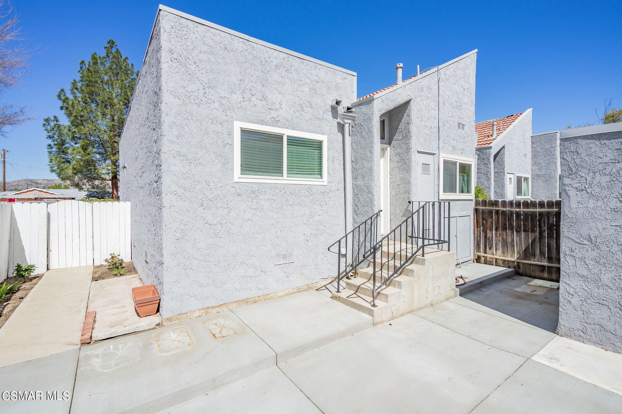 6392 Katherine Road, Unit C Simi Valley, CA 93063 - Photo 5 of 31 a view of a house with a small yard and wooden floor and fence