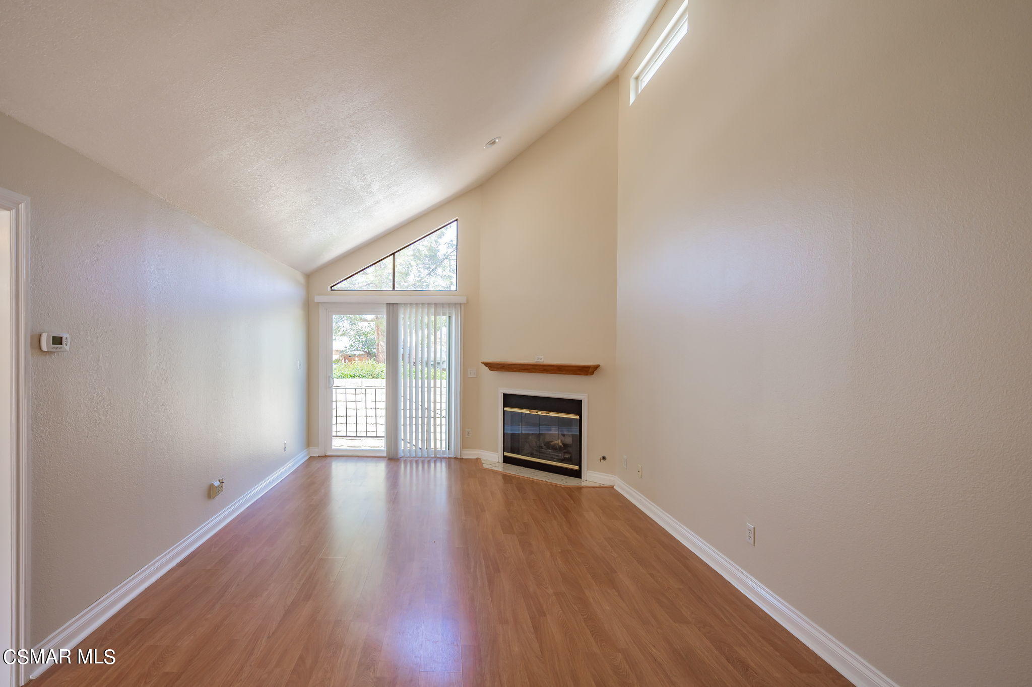6392 Katherine Road, Unit C Simi Valley, CA 93063 - Photo 7 of 31 an empty room with wooden floor a fireplace and windows