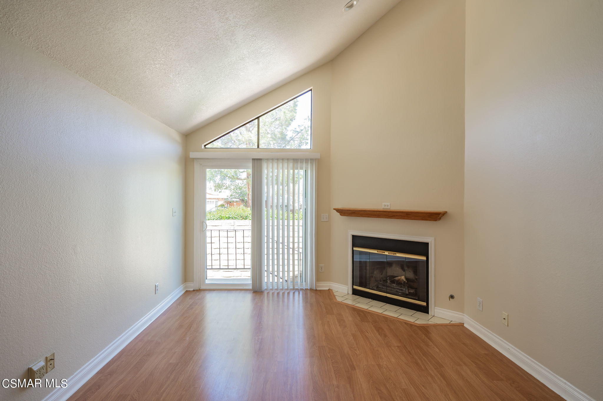6392 Katherine Road, Unit C Simi Valley, CA 93063 - Photo 9 of 31 an empty room with wooden floor fireplace and windows