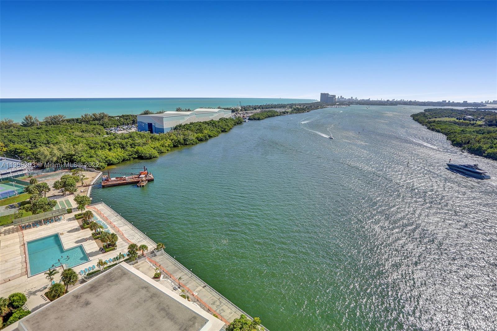 an aerial view of a house with a yard and lake view