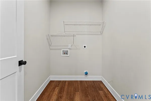 a view of a hallway with wooden floor and entryway