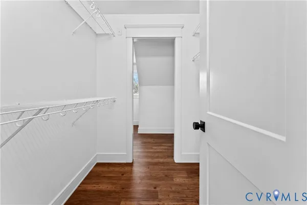 a view of a small space with wooden floor and a window