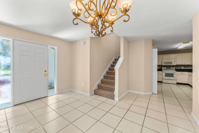 a view of an entryway with a chandelier