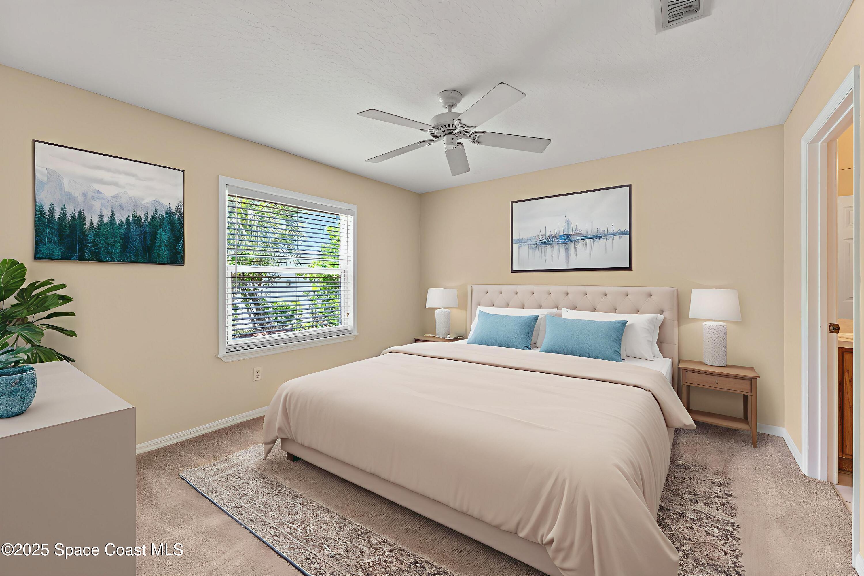 36 Sunset Street Satellite Beach, FL 32937 - Photo 14 of 45 a bedroom with a large bed and a window