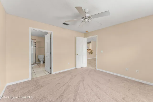 a view of a big room with closet and chandelier fan