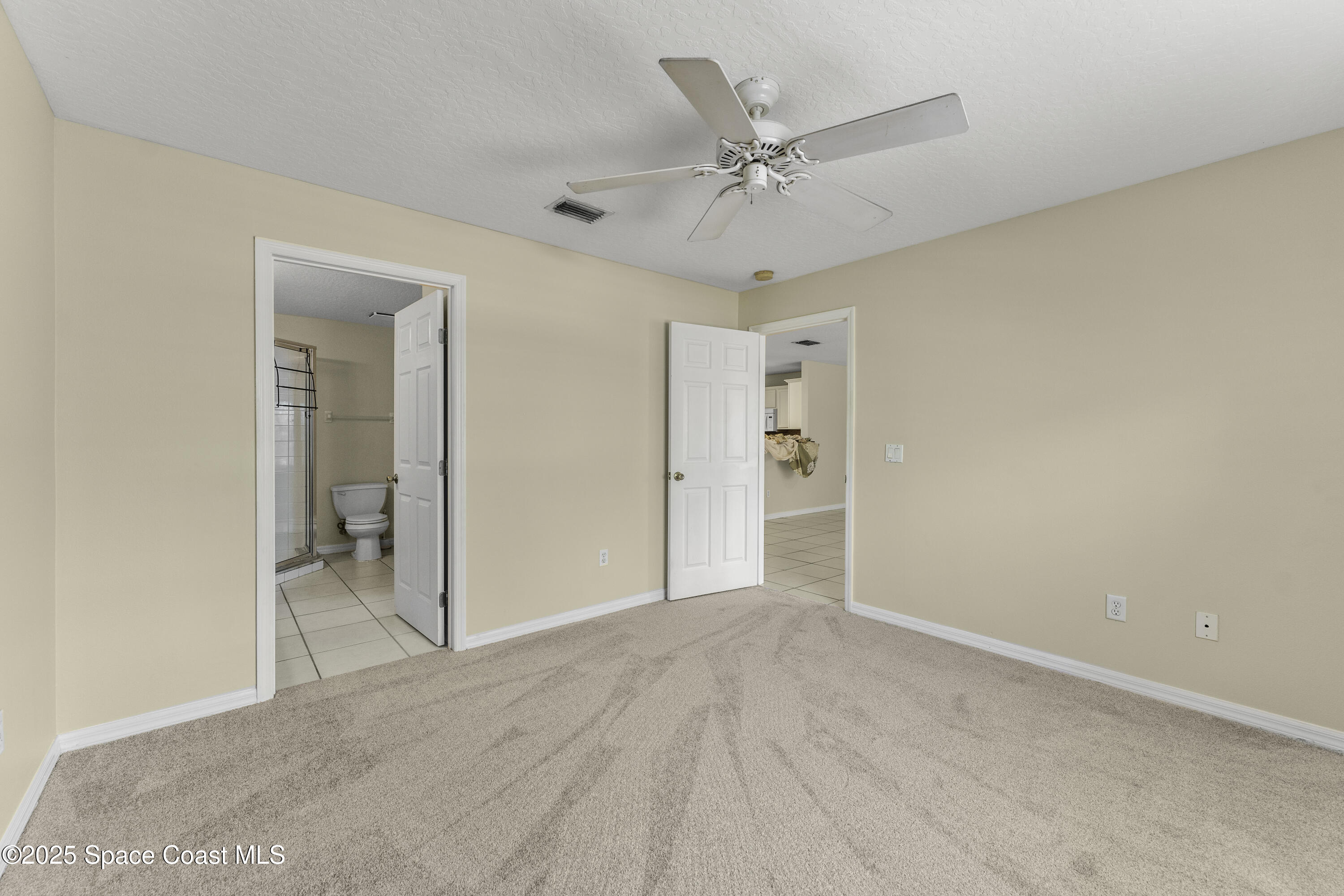 36 Sunset Street Satellite Beach, FL 32937 - Photo 16 of 45 a view of a big room with closet and chandelier fan