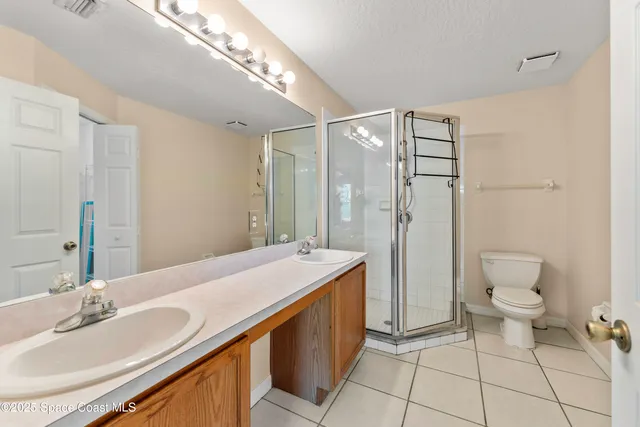 a spacious bathroom with a granite countertop sink a toilet and a mirror