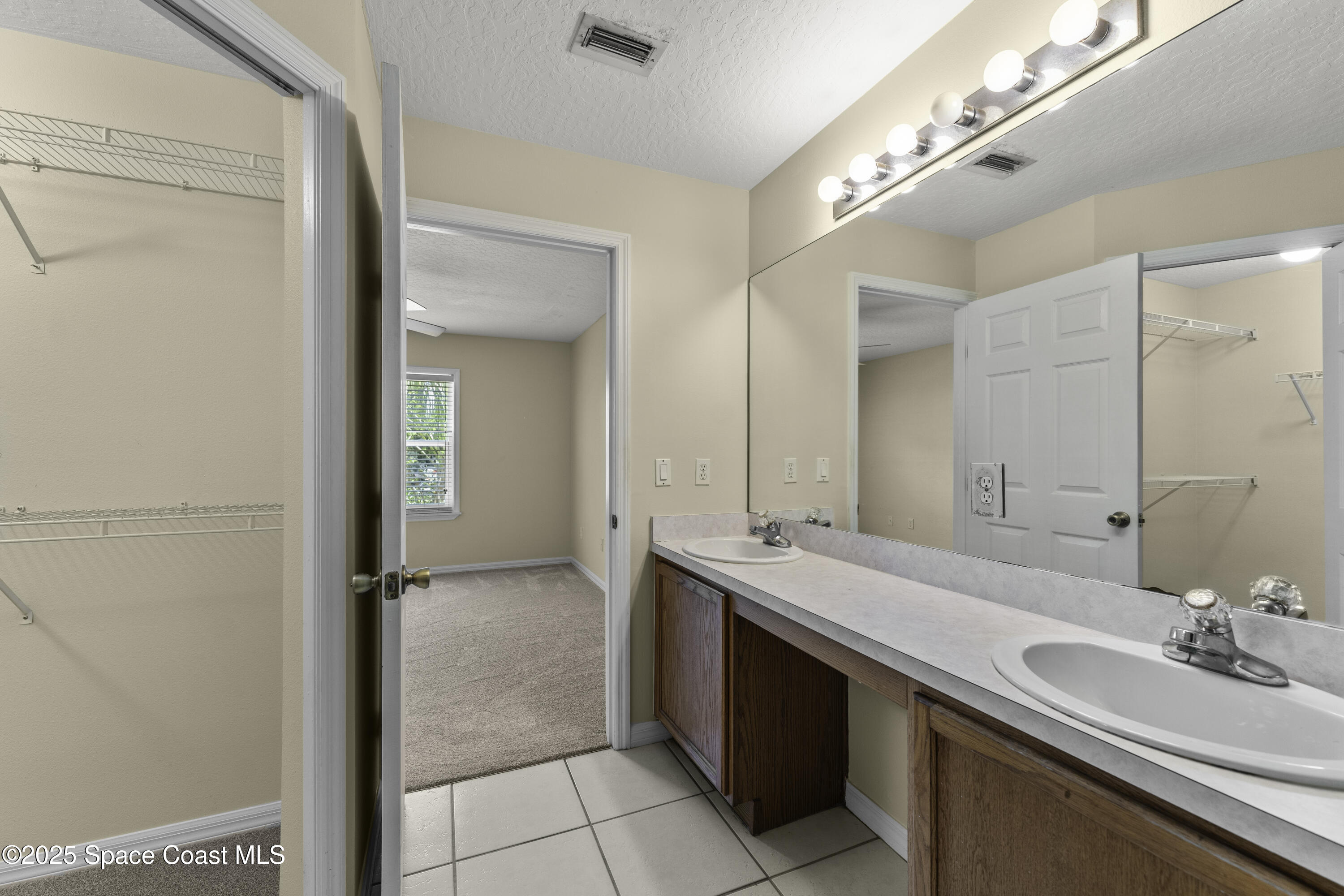 36 Sunset Street Satellite Beach, FL 32937 - Photo 19 of 45 a bathroom with a sink and a mirror