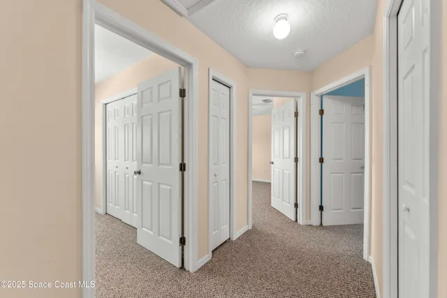 a view of a hallway with closet area