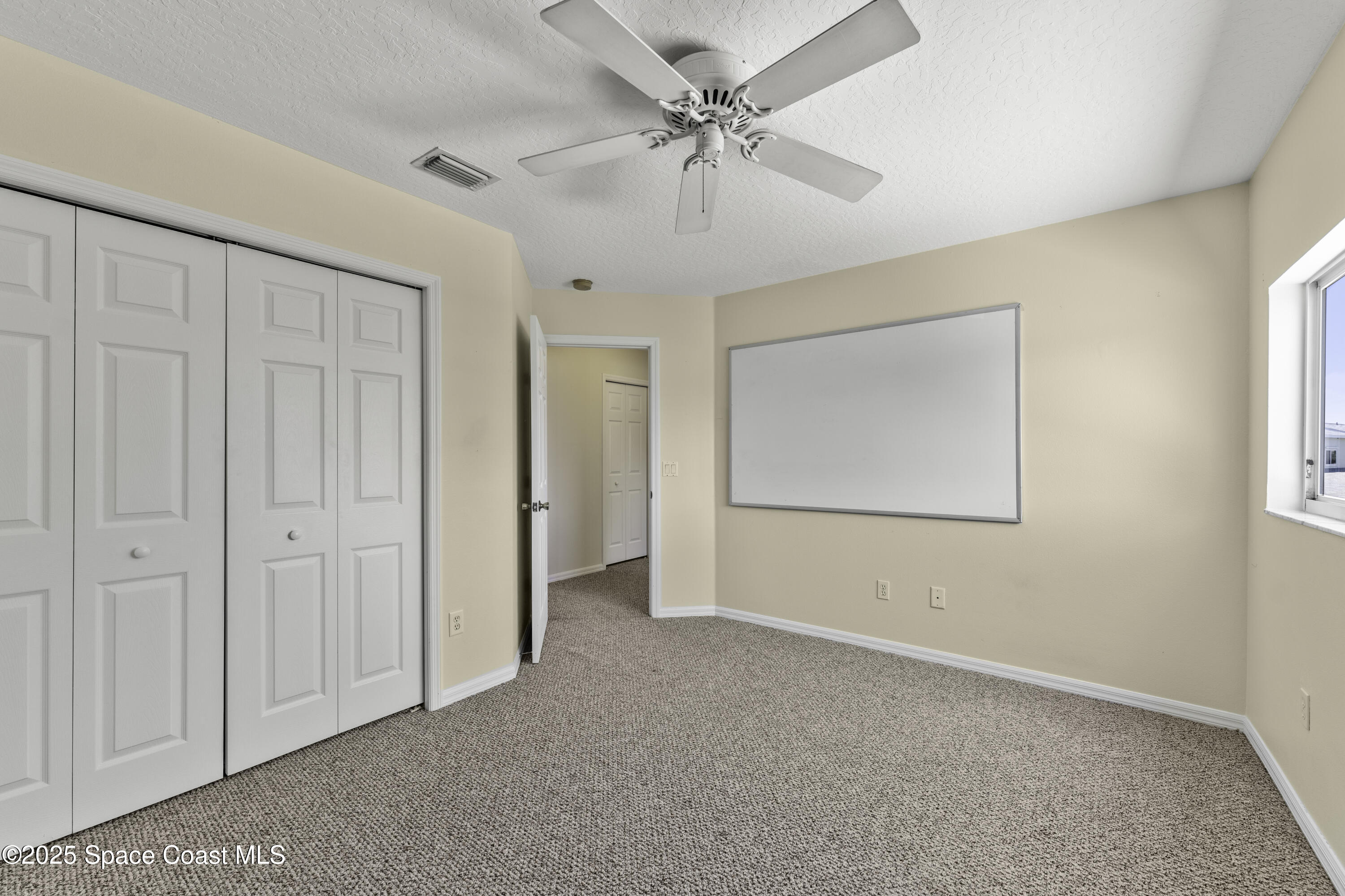 36 Sunset Street Satellite Beach, FL 32937 - Photo 23 of 45 an empty room with windows and fan