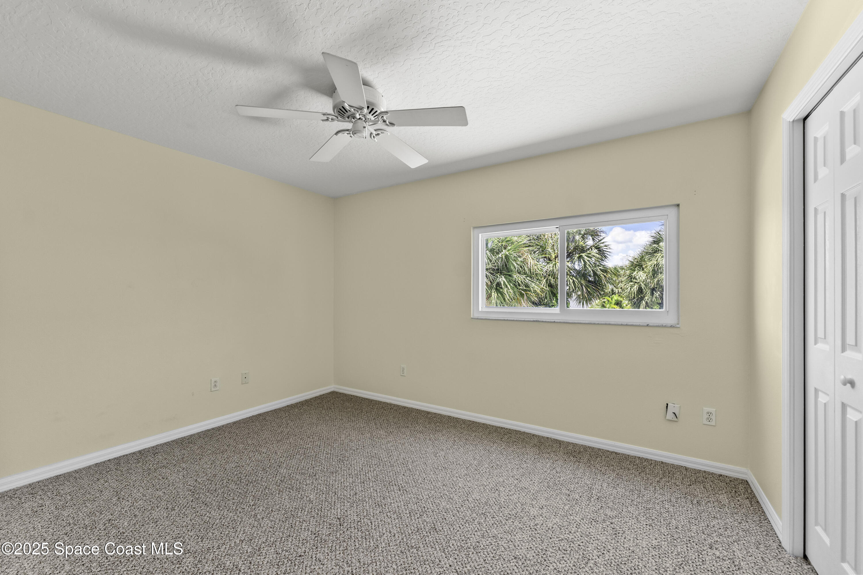 36 Sunset Street Satellite Beach, FL 32937 - Photo 24 of 45 an empty room with a window and ceiling fan