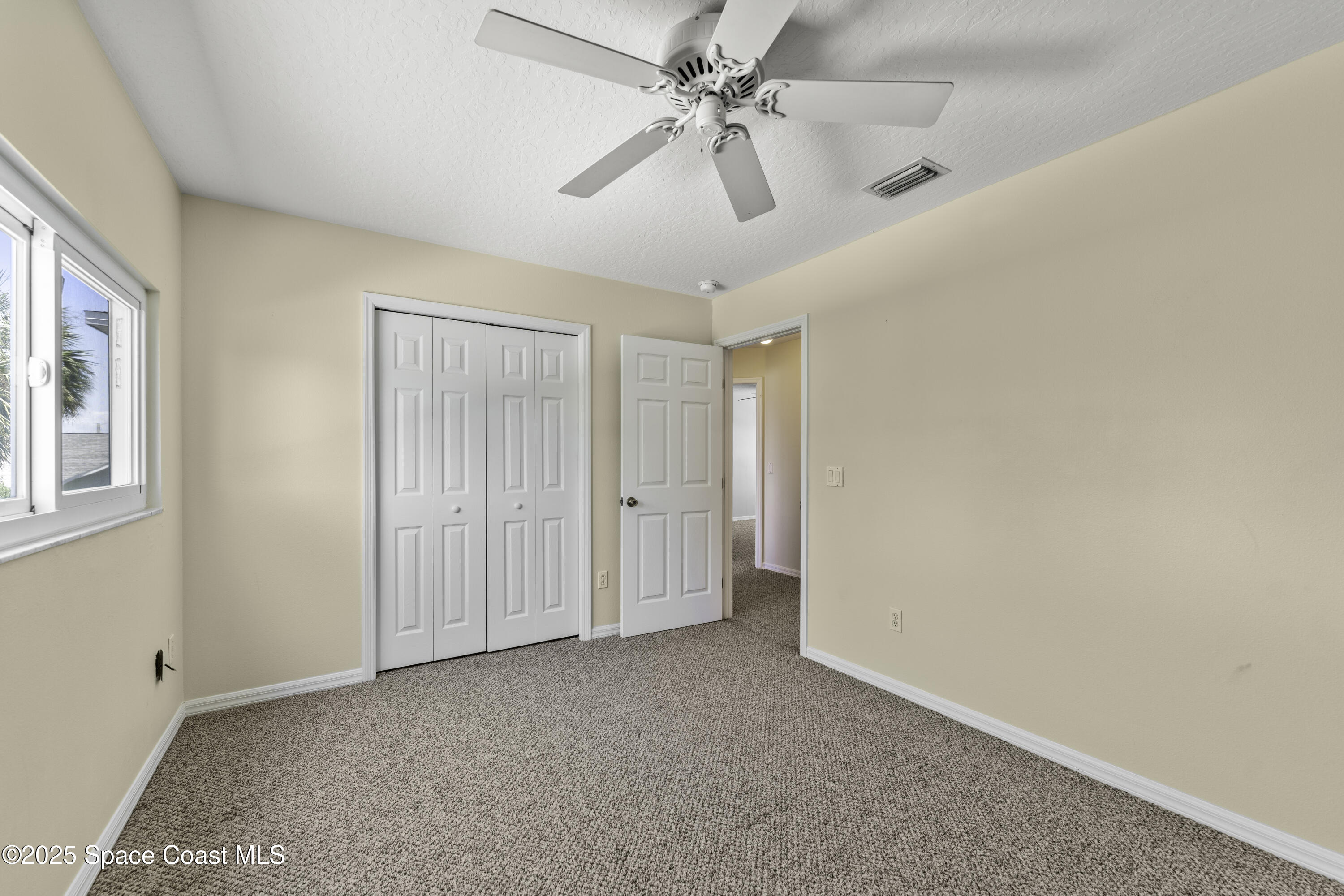 36 Sunset Street Satellite Beach, FL 32937 - Photo 25 of 45 a view of a livingroom with a ceiling fan and window