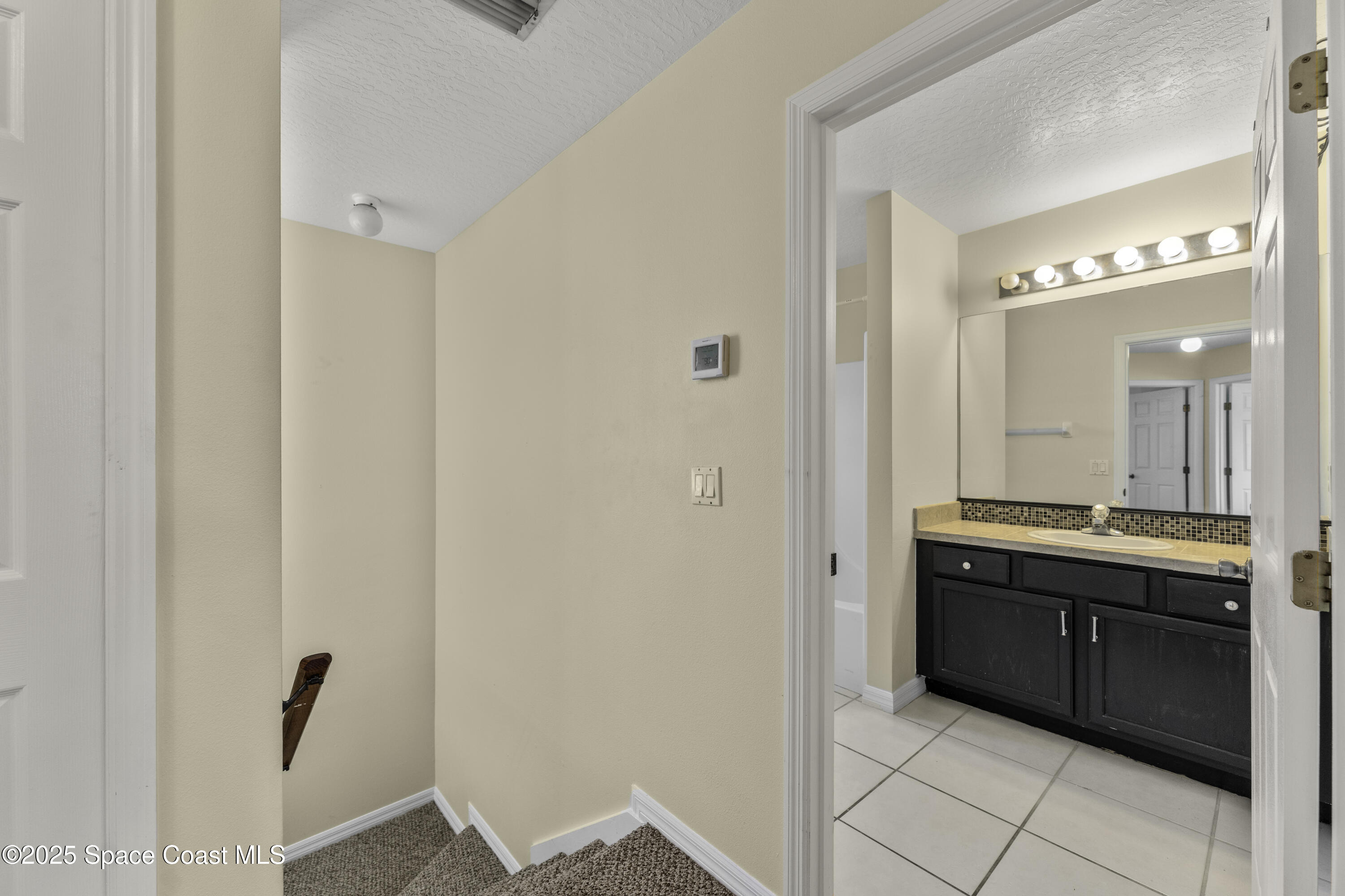 36 Sunset Street Satellite Beach, FL 32937 - Photo 28 of 45 a spacious bathroom with a double vanity sink and mirror