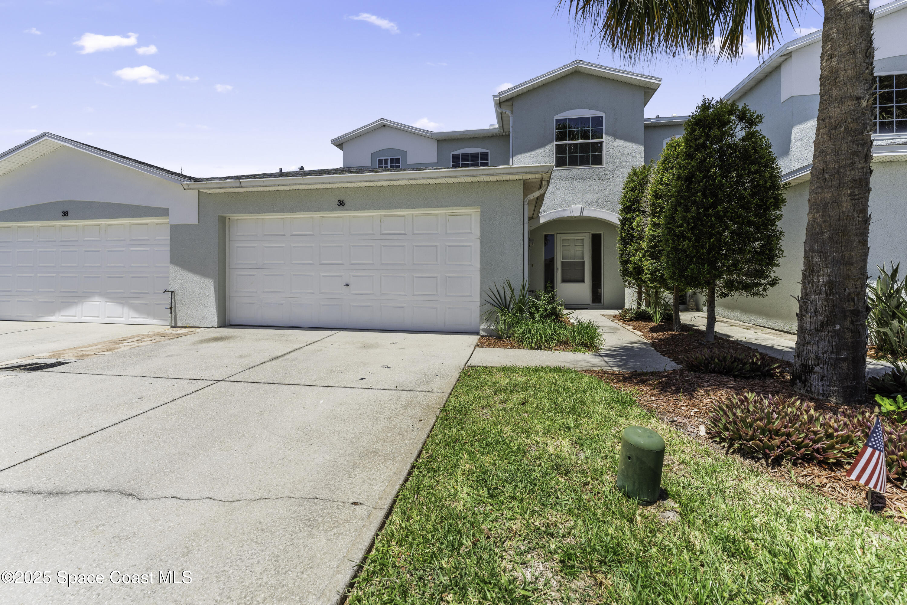 36 Sunset Street Satellite Beach, FL 32937 - Photo 3 of 45 a front view of a house with garden