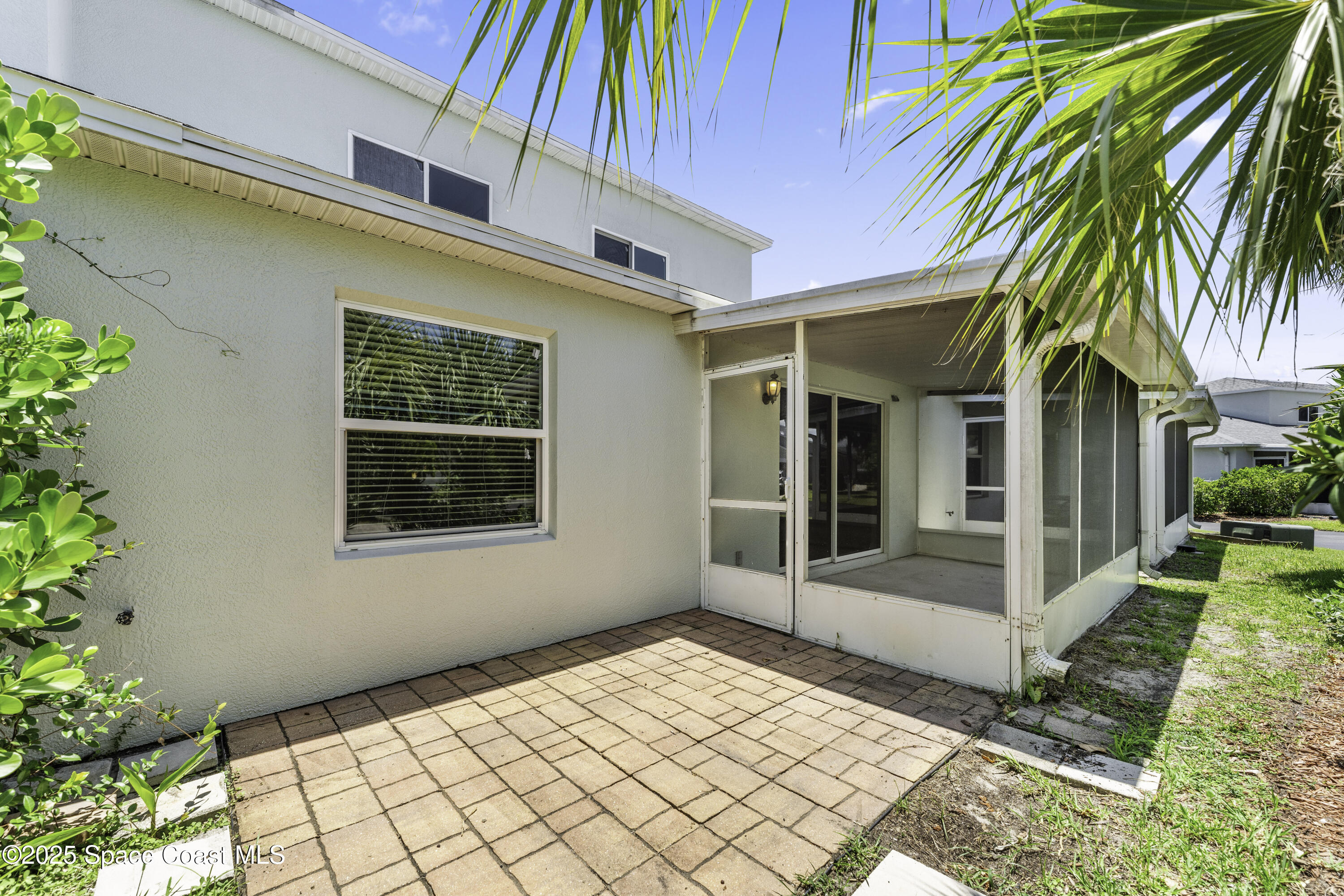 36 Sunset Street Satellite Beach, FL 32937 - Photo 32 of 45 a view of a white house with a large window and potted plants
