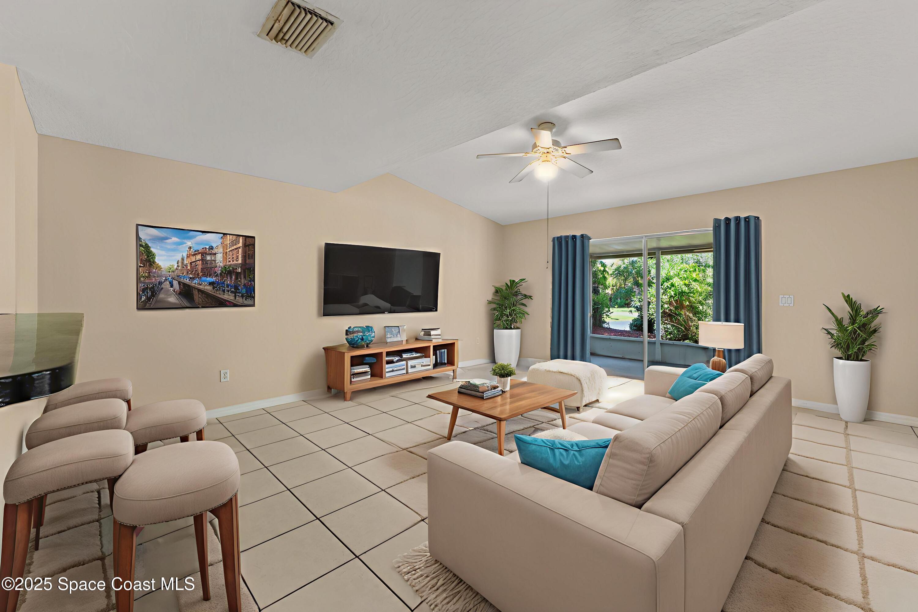 36 Sunset Street Satellite Beach, FL 32937 - Photo 9 of 45 a living room with furniture and a flat screen tv