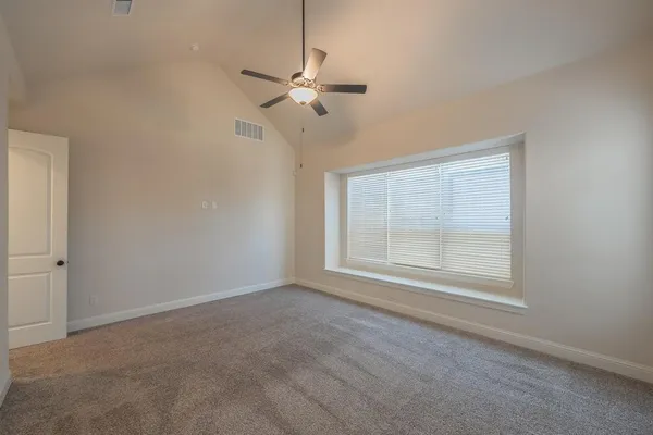 en empty room with windows and fan