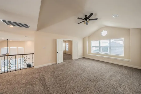 a view of a livingroom with a ceiling fan and window