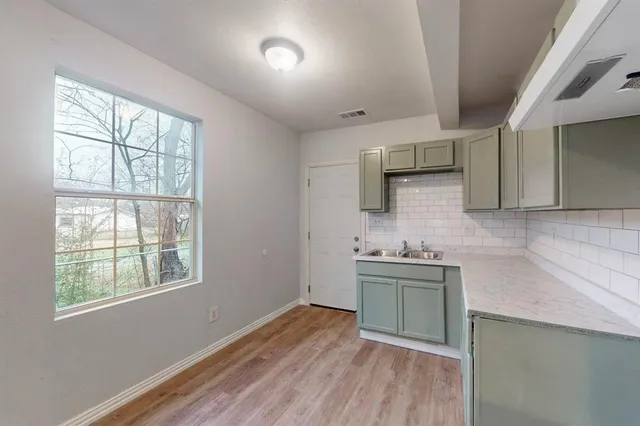 a kitchen with a sink stove and cabinets