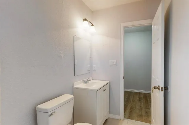a bathroom with a toilet a sink and mirror