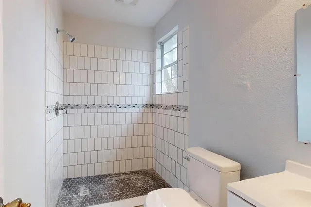 a bathroom with a toilet and a shower