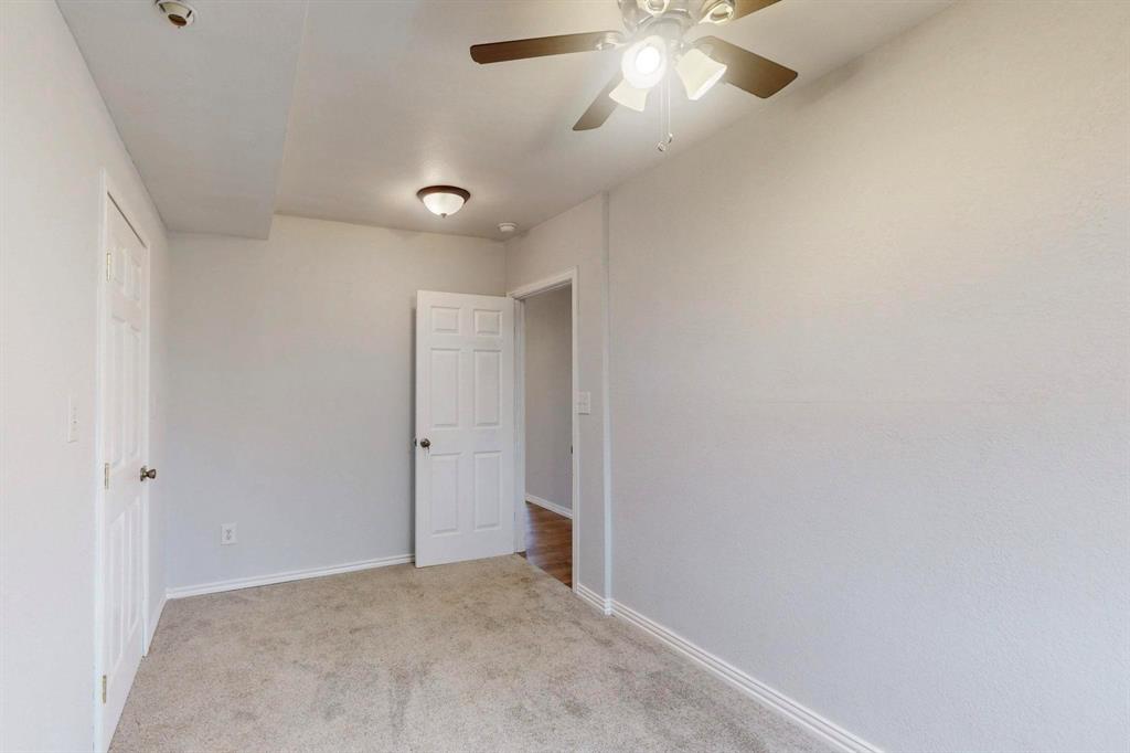 505 Oak Street Commerce, TX 75428 - Photo 19 of 28 wooden floor in an empty room