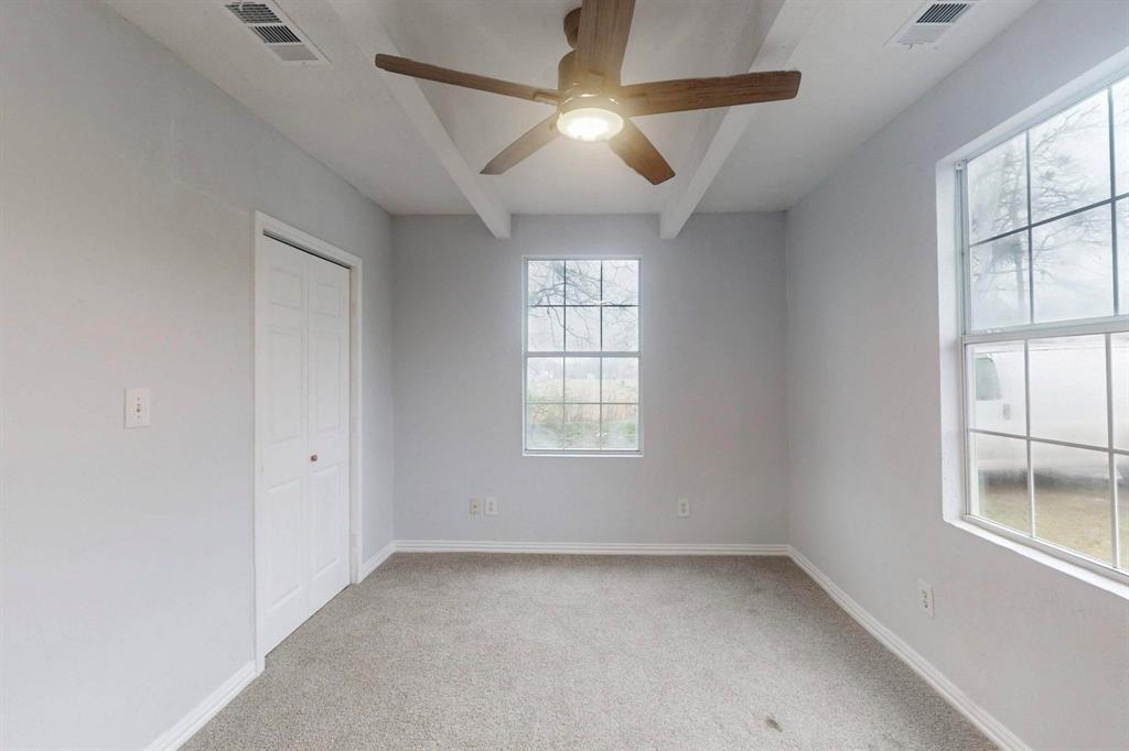 505 Oak Street Commerce, TX 75428 - Photo 22 of 28 wooden floor in an empty room with a window